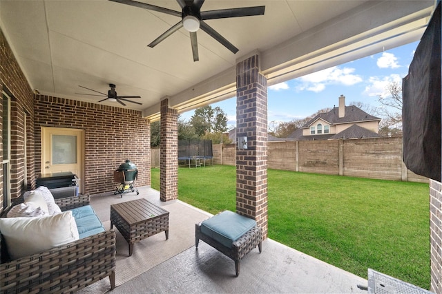 view of patio / terrace with a trampoline, a grill, outdoor lounge area, and ceiling fan