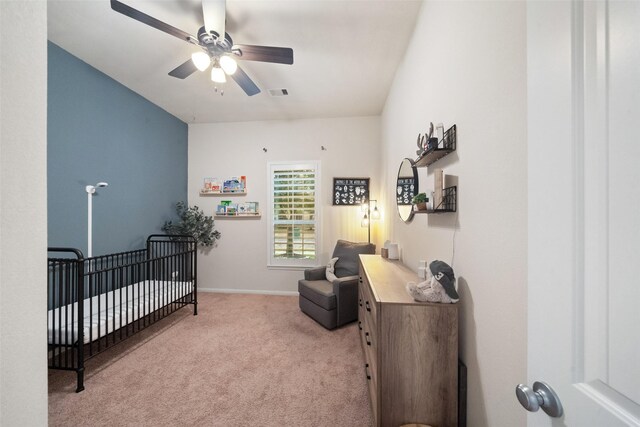 carpeted bedroom featuring a crib