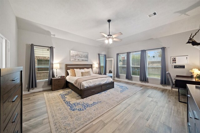 bedroom featuring ceiling fan, vaulted ceiling, and light wood-type flooring