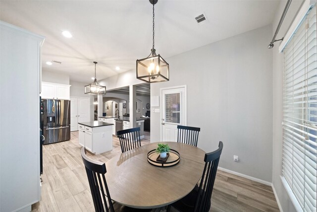 dining space with light hardwood / wood-style flooring