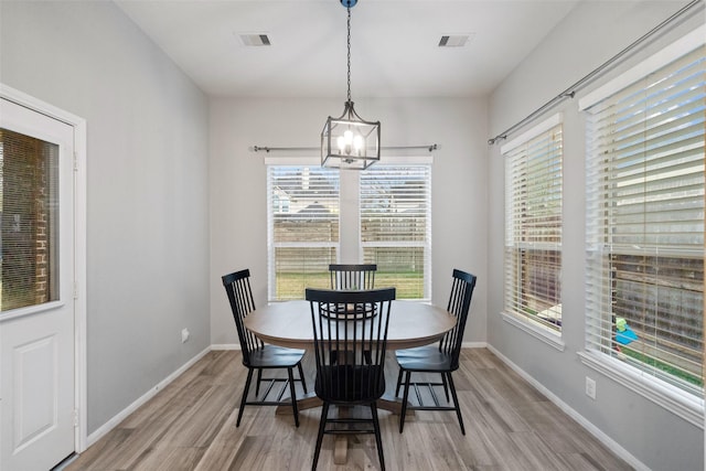 dining room featuring a chandelier and light wood-type flooring