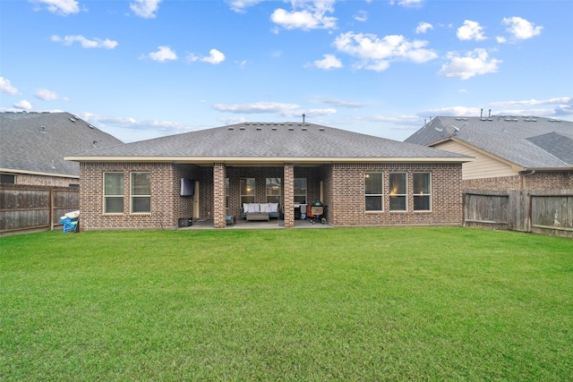 back of property featuring a patio and a lawn