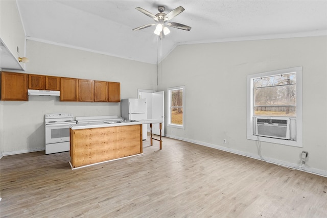 kitchen featuring lofted ceiling, white appliances, a breakfast bar area, ceiling fan, and a kitchen island