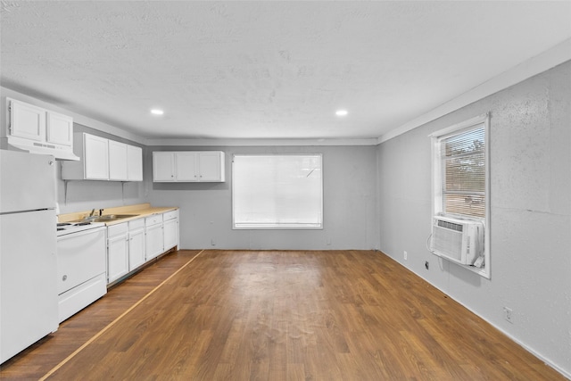 kitchen featuring sink, white cabinetry, dark hardwood / wood-style flooring, cooling unit, and white appliances