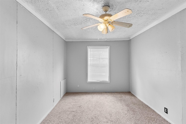 carpeted empty room with ceiling fan and a textured ceiling