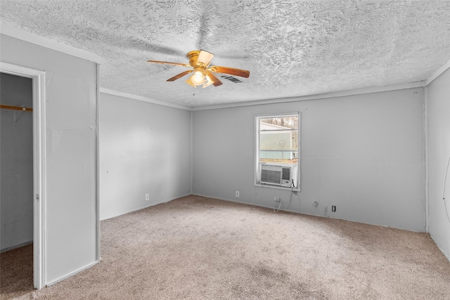 unfurnished bedroom featuring cooling unit, light colored carpet, ceiling fan, and a textured ceiling