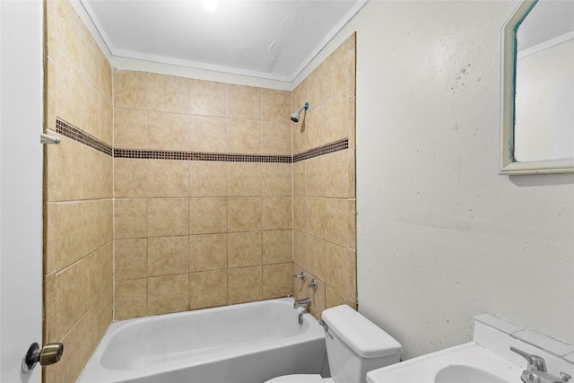 bathroom with tiled shower / bath combo and toilet