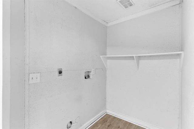 clothes washing area featuring washer hookup, hookup for a gas dryer, hardwood / wood-style flooring, and electric dryer hookup