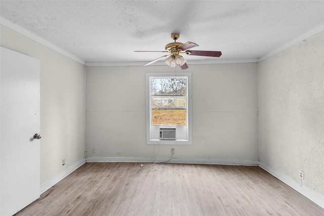 unfurnished room featuring cooling unit, ceiling fan, a textured ceiling, and light wood-type flooring