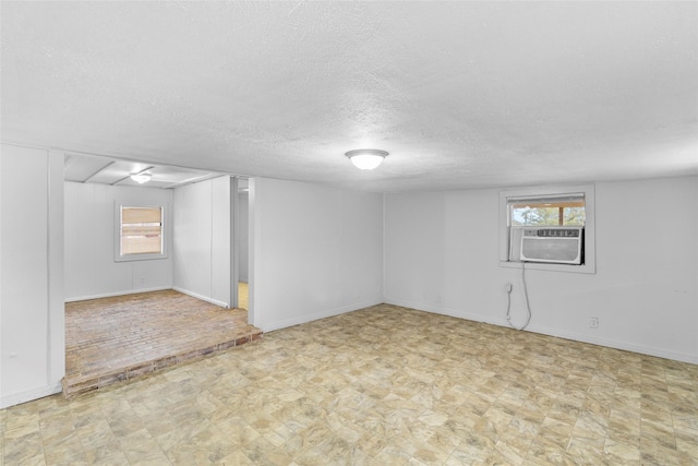 basement with cooling unit and a textured ceiling