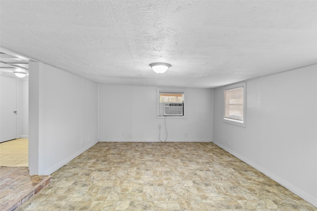 basement with cooling unit and a textured ceiling