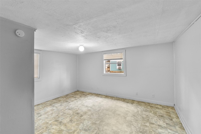 unfurnished room with cooling unit and a textured ceiling