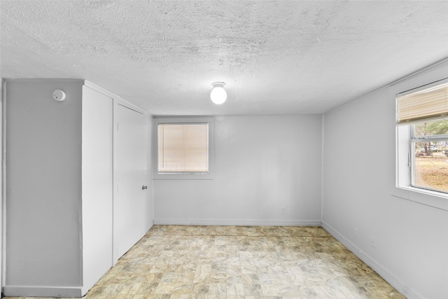 empty room featuring a textured ceiling