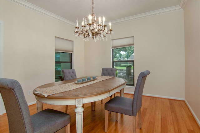 dining space with ornamental molding, light hardwood / wood-style floors, and a chandelier