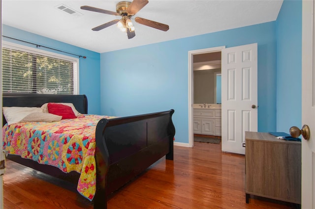 bedroom featuring sink, wood-type flooring, and ceiling fan