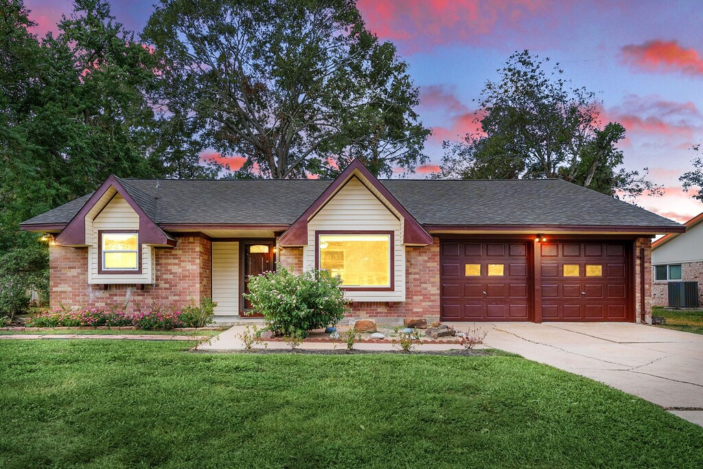 13106 Suzanne St, Stafford, TX 77477 - single story home with a garage, a yard, and central AC unit