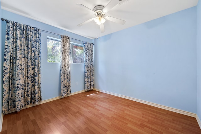 empty room with wood-type flooring and ceiling fan