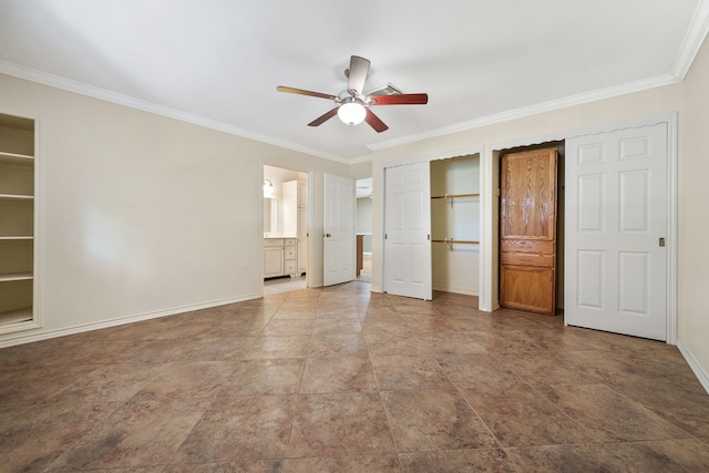 unfurnished bedroom featuring crown molding, two closets, ensuite bath, and ceiling fan