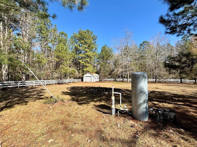 view of yard with a storage shed and a rural view