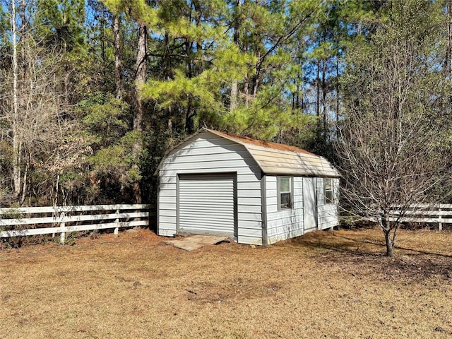 view of outbuilding with a garage and a lawn