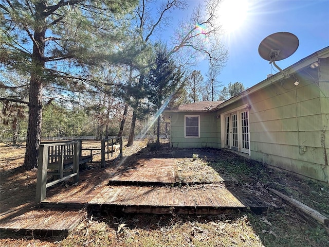 view of yard featuring french doors and a deck