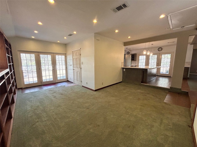 unfurnished living room with french doors and dark colored carpet