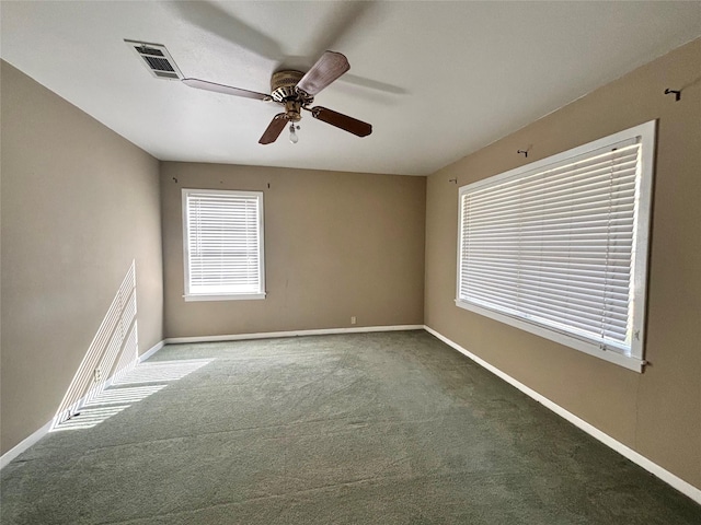 carpeted spare room featuring ceiling fan