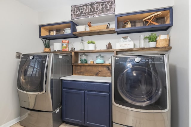 laundry room featuring separate washer and dryer and cabinets