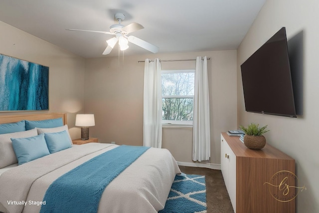 bedroom with ceiling fan and dark colored carpet