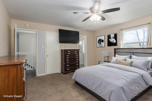 bedroom featuring light carpet, a closet, and ceiling fan