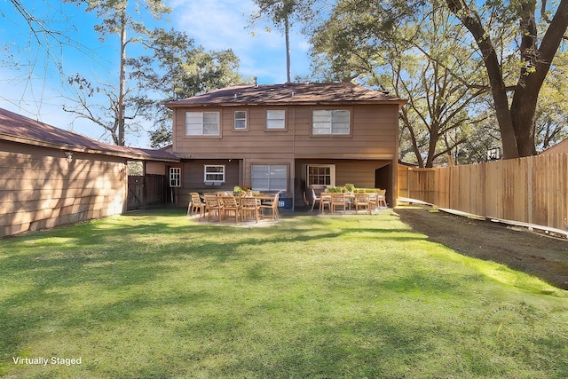 back of property with a patio and a lawn