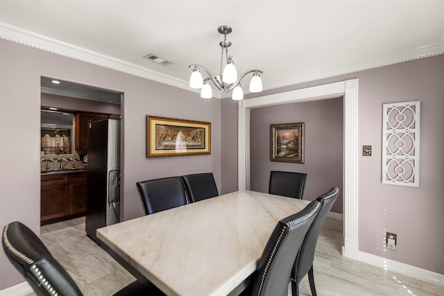 dining space featuring ornamental molding and a chandelier