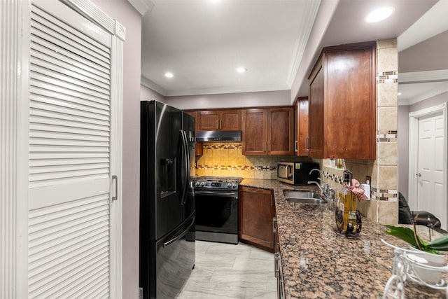 kitchen featuring sink, ornamental molding, appliances with stainless steel finishes, dark stone counters, and decorative backsplash