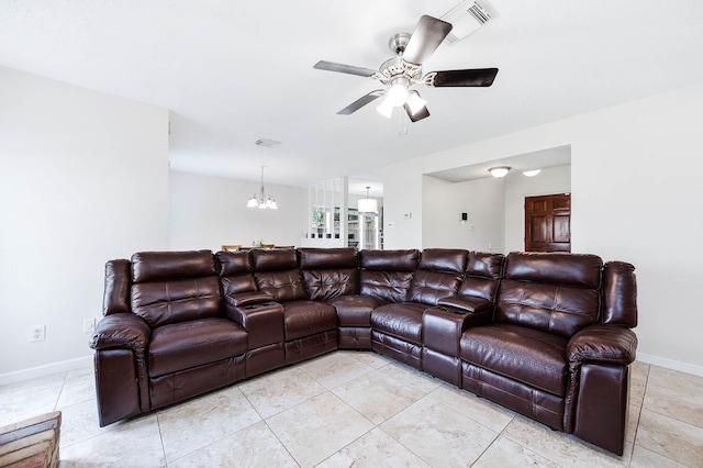 tiled living room featuring ceiling fan with notable chandelier