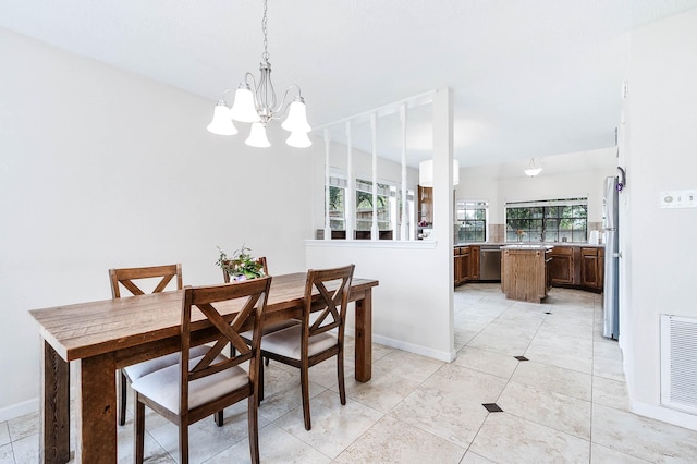 tiled dining area featuring a notable chandelier