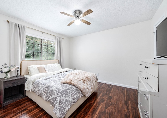 bedroom with dark hardwood / wood-style flooring, ceiling fan, and a textured ceiling