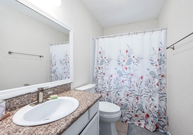 bathroom featuring vanity, tile patterned flooring, toilet, and a textured ceiling