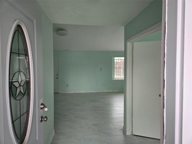 hall with a textured ceiling