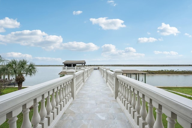 view of dock with a water view and a gazebo