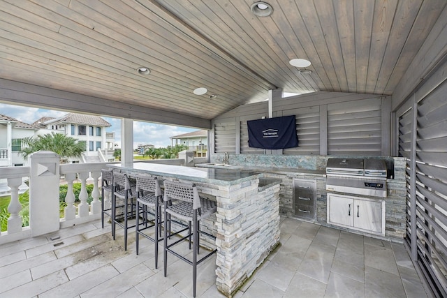 view of patio / terrace with grilling area and an outdoor wet bar