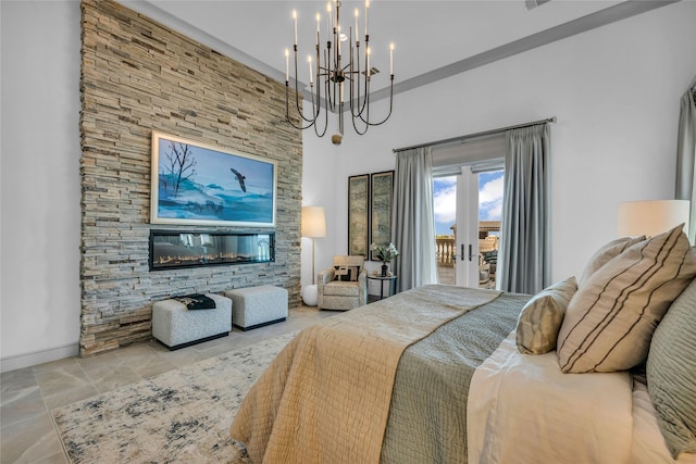 bedroom with access to outside, french doors, a chandelier, and a high ceiling