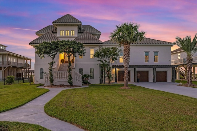 1809 Laguna Harbor Estate Blvd, Port Bolivar, TX 77650 - mediterranean / spanish-style home with a garage and a lawn