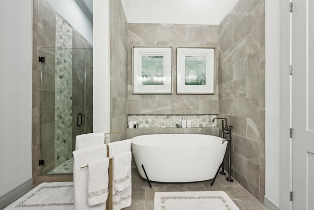 bathroom featuring tile walls, tile patterned floors, and independent shower and bath