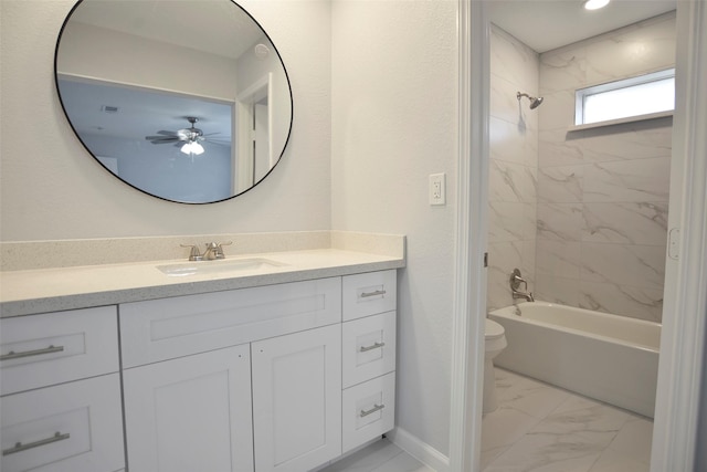 full bathroom featuring vanity, toilet, and tiled shower / bath combo