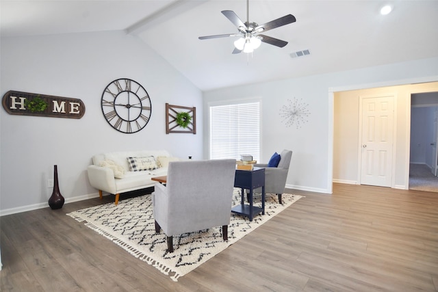 dining area featuring ceiling fan, hardwood / wood-style floors, and vaulted ceiling with beams