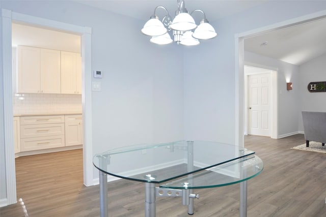 dining area featuring a notable chandelier and light hardwood / wood-style flooring