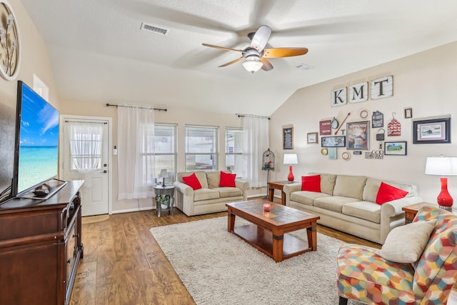 living room featuring ceiling fan, lofted ceiling, and hardwood / wood-style floors