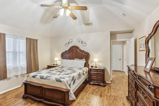 bedroom featuring lofted ceiling, light hardwood / wood-style floors, and ceiling fan