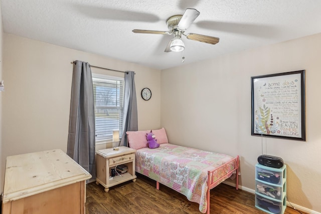 bedroom featuring ceiling fan, dark hardwood / wood-style floors, and a textured ceiling