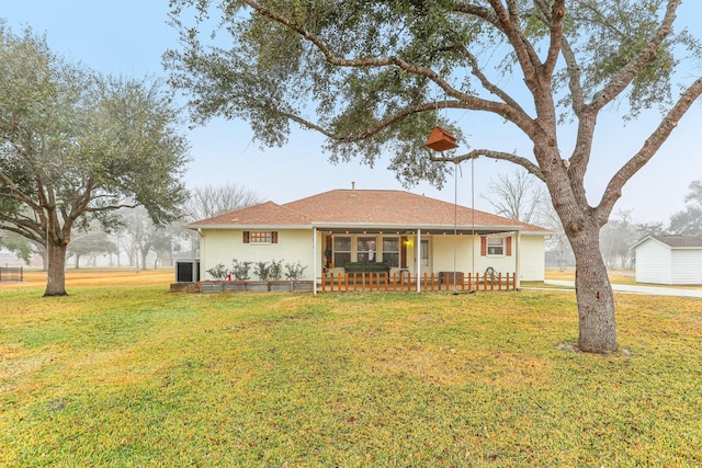 rear view of house with a lawn